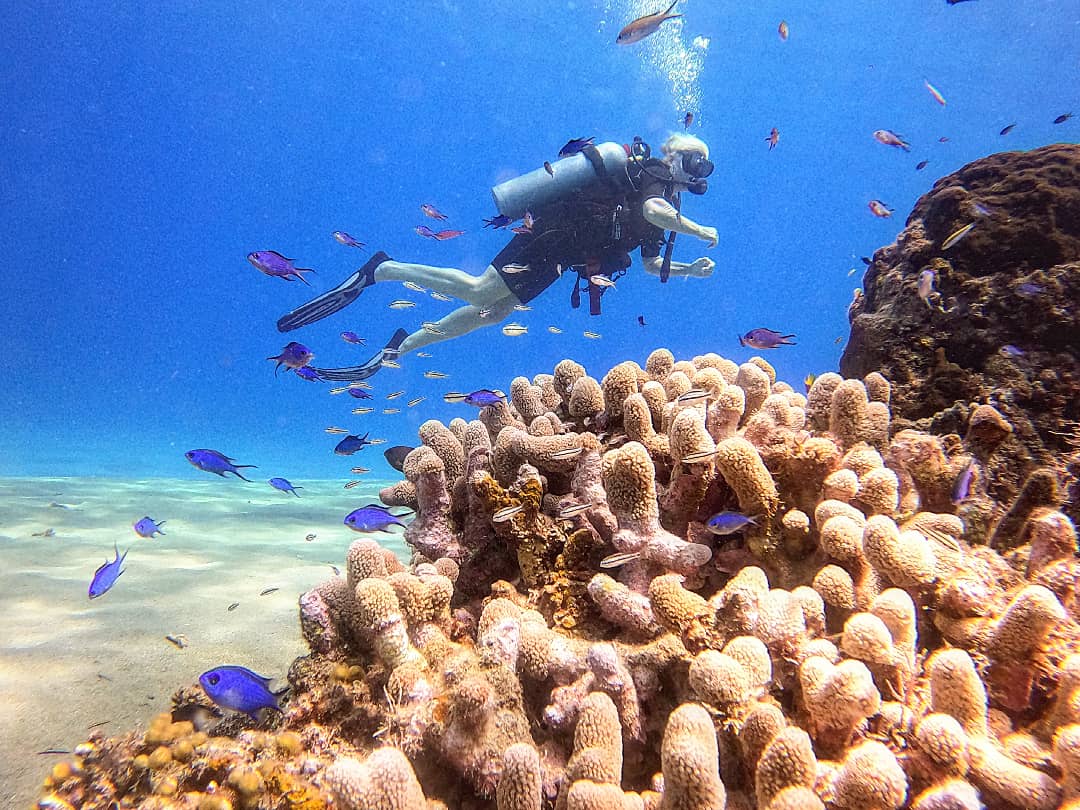 First-time diver on the reef with an instructor